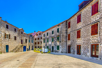 Fototapeta premium Colorful ancient square in Starigrad place, summer travel destination in Croatia, Iland Hvar scenery.
