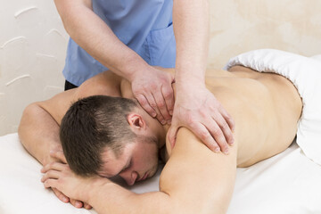Fototapeta na wymiar Young man on wellness treatments sports massage 