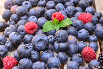 Blueberries with raspberries on a wooden table