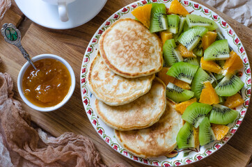 Pancakes with kiwi mandarins and jam for breakfast
