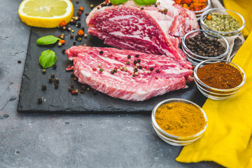 fresh meat with ingredients for cooking on dark background