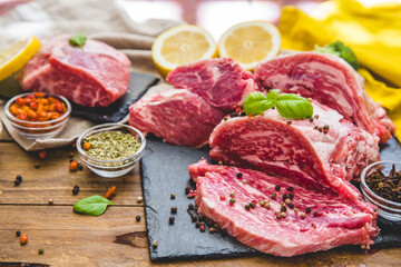 Raw juicy meat steak on dark wooden background