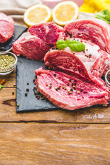 Raw juicy meat steak on dark wooden background