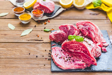 Raw juicy meat steak on dark wooden background