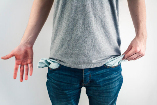 Man showing empty pockets without money