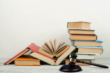 Law concept open book with wooden judges gavel on table in a courtroom or law enforcement office,...