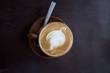 cofee cup on dark wood texture