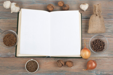 Recipe cook blank book on wooden background, spoon, rolling pin, checkered tablecloth