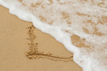 Drawing of heart on the sand