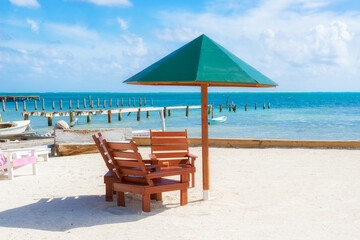 Umbrella and chairs on the beach in Caye Caulker, Belize.