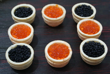 Black and red caviar for guests and friends.