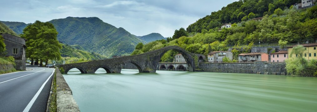 panorama with bridge and green river in Italy © sergejson