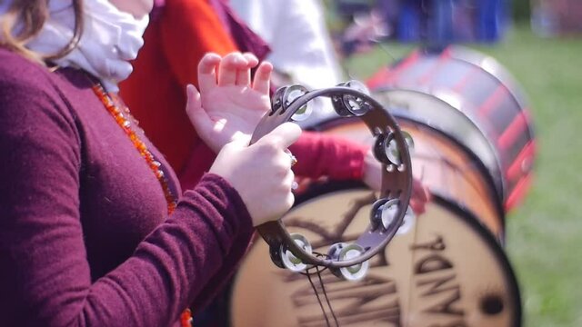 Woman is Playing an Old Musical Instrument