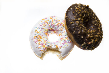 Isolated doughnuts with colorful chocolate glazing.