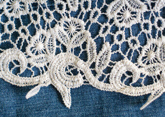 Openwork fabric lace border on denim background