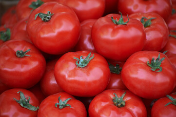 Heap of large size tomatoes on the counter