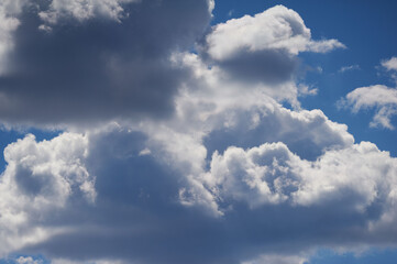 Fototapeta na wymiar White woolpack clouds on the blue sky
