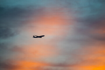 Airplane flying during majestic sunset