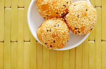 fried glutinous ball topping sesame filled mushed yellow bean on cup
