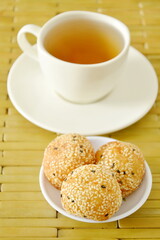 fried glutinous ball topping sesame stuffed mushed yellow bean with tea cup