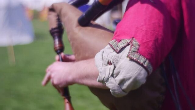 Man Holds Old Bagpipe Under His Arm