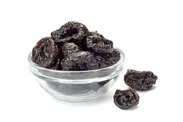 Bowl of dried plums on white