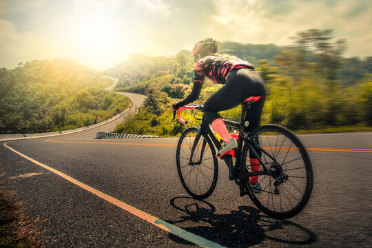 Women cycling mountain road bike in the morning