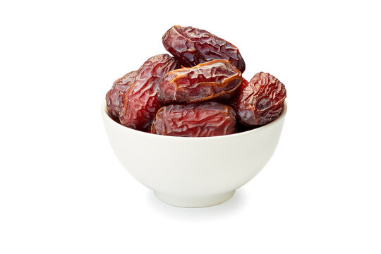 Bowl of dried date fruits on white