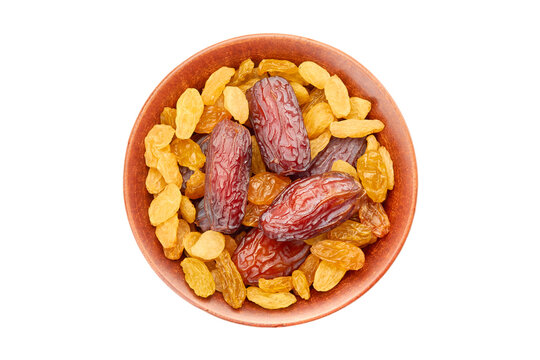 Bowl of raisins and date fruits on white