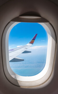Close up Airplane window with airplane wing