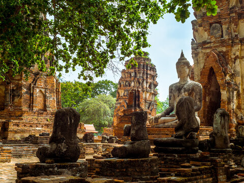 Only intact ancient Buddha statue among the destroyed statues in Ayutthaya historical park, Thailand.