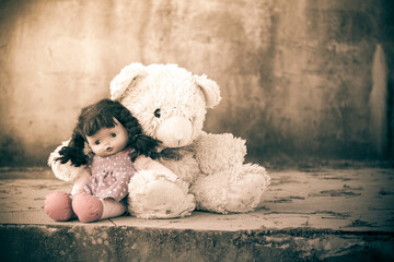 doll sad with teddy bear ,vintage tone
