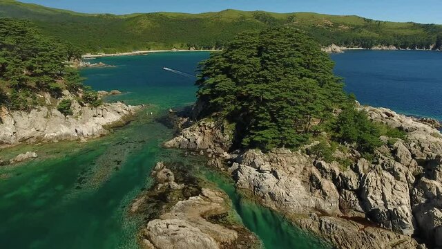 Vityaz Island of Languishing Heart. Far East Marine Biosphere Reserve Primorsky Krai Vladivostok Russia. Unique National park Japan Sea ocean. Aerial Helicopter Drone flight. Summer sunny day. 4k