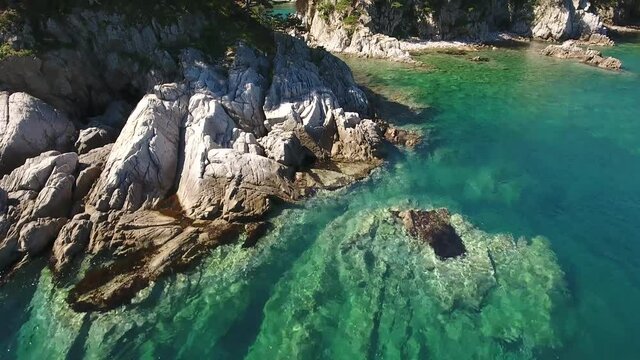 Treees on Island Languishing Heart close blue water. Far East Marine Biosphere Reserve Primorsky Krai Vladivostok Russia. Unique National park Japan Sea. Aerial Helicopter Drone flight forward