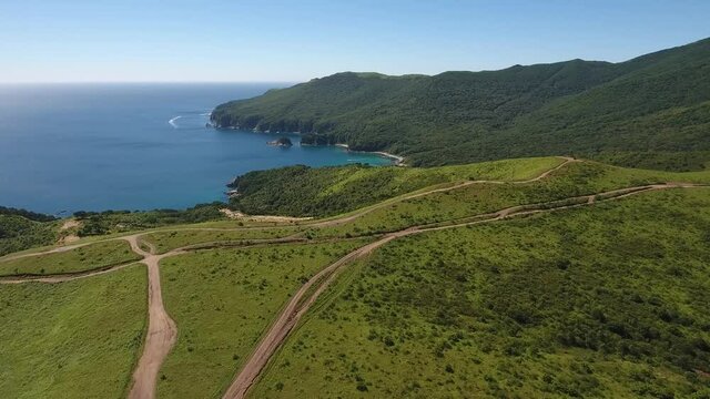 Bay of Languishing Heart up hills forward flight to ocean. Far East Marine Biosphere Reserve Primorsky Krai Vladivostok Russia. Unique National park Japan Sea. Aerial Helicopter Drone flight around