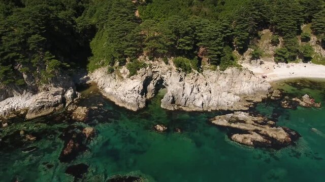 Epic dissent into Cave grotto Far East Marine Reserve Primorsky Krai Vladivostok Russia. Unique National park Japan Sea blue ocean. Aerial Helicopter Drone flight. Summer sunny day. 4k