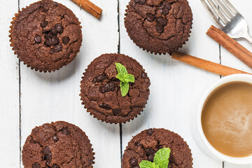 chocolate muffin with mint on a wooden table