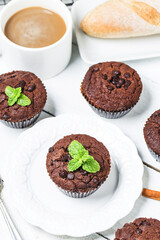 chocolate muffin with mint on a wooden table
