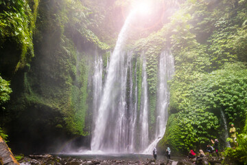 Fototapeta na wymiar Layered water flows, cool air and green scenery are attractions that tourist can enjoy when they visit Tiu Kelep waterfall in Lombok, Indonesia.