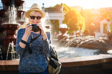 Woman tourist with a digital camera in the old town.