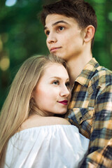 Fototapeta premium Young Couple Hugging In Forest