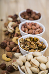 Nuts in a plate on a  wooden table.