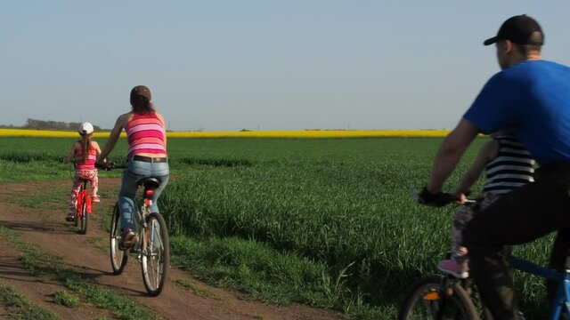 A sports family on bicycles. Parents with children ride on bicycles. Active family vacation.