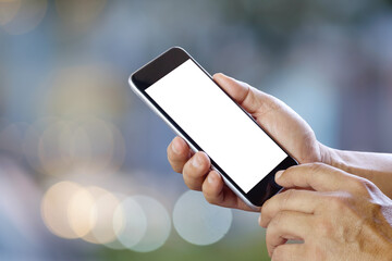Man using smartphone on street night. Blank screen smartphone for Graphic display montage.