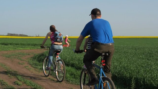 A sports family on bicycles. Parents with children ride on bicycles. Active family vacation.