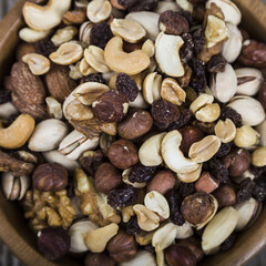 Nuts in a wooden bowl  on a  wooden table.