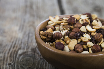 Nuts in a wooden bowl  on a  wooden table.