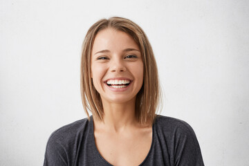 Positive human facial expressions and emotions. Cheerful attractive teenage girl with bob hairstyle...