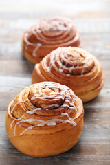Cinnamon buns on wooden table