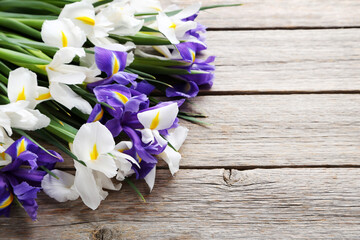 Bouquet of iris flowers on grey wooden table